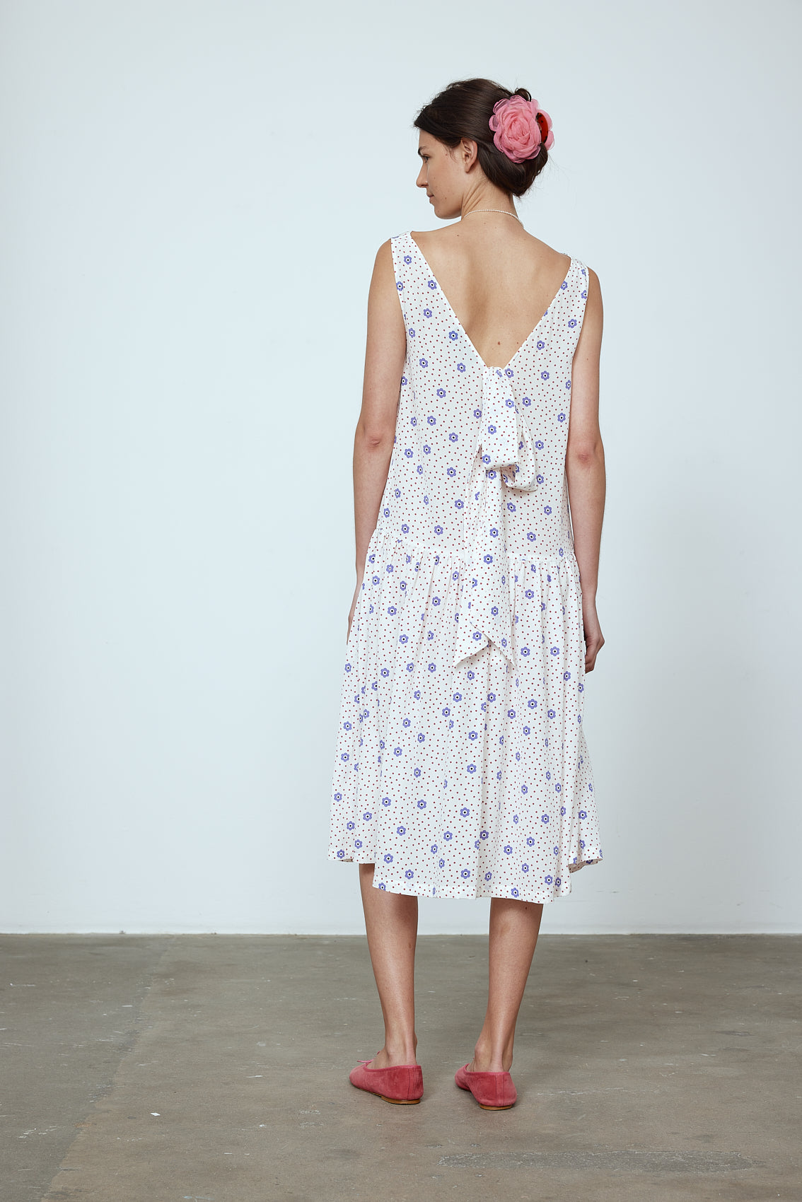 The Sonya Dress is an oversized style with a high neckline and low back featuring a large bow detail. The dress is made from soft mulberry silk featuring a White Daisy print. Style it with an open shirt or denim jacket. Also available in Beaded Emerald Silk Velvet, Navy Flower Poplin, and Black Silk Velvet. Material: 100% cotton.