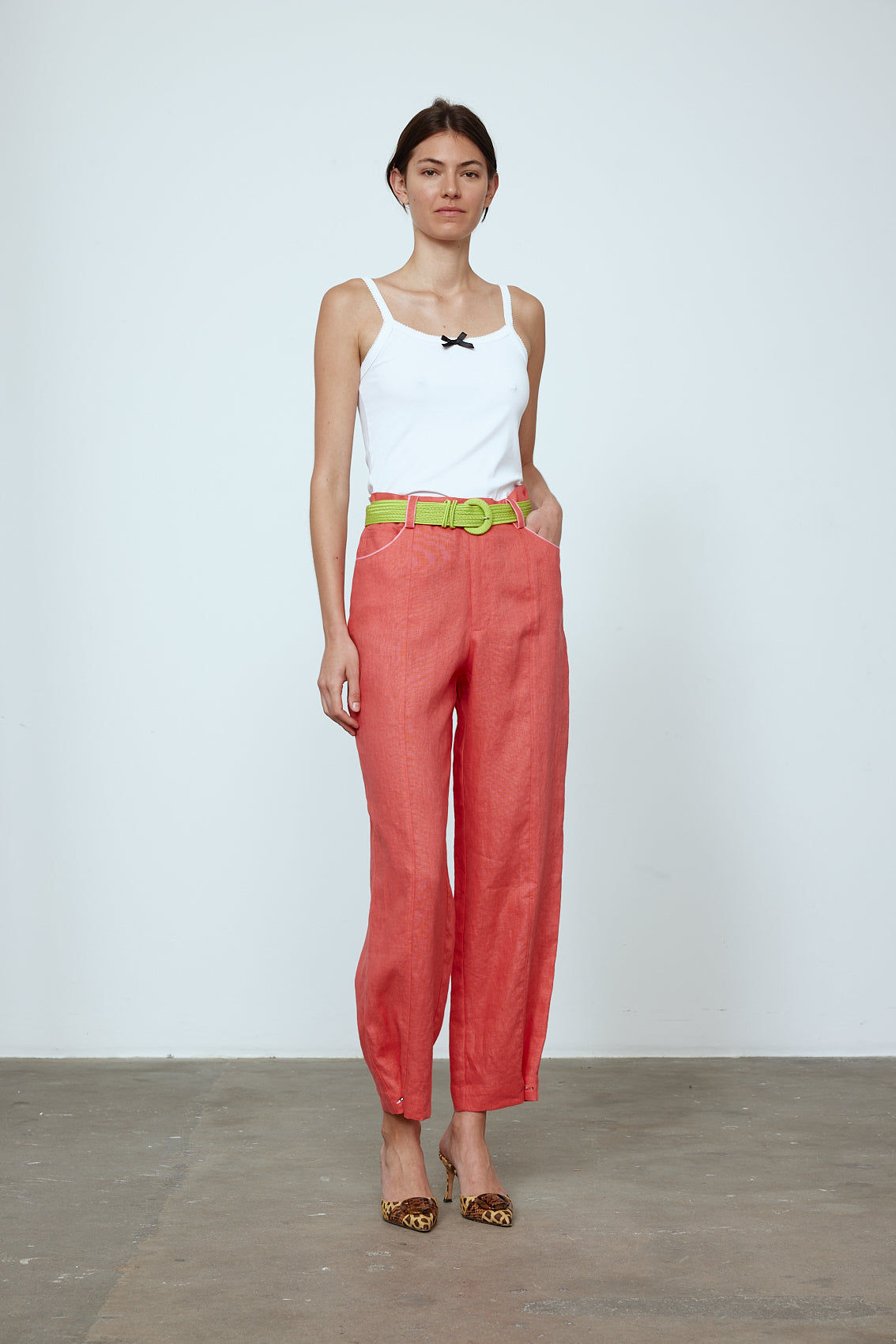 The Emma Pants in Orange Linen. The pants feature cargo details on the side and large pockets with piping details in a contrasting color. Easily modify the shape of the pants with a button adjustment. Style them with a t-shirt, blouse, or a matching Emma Jacket in Orange Linen. Also available in Pink and Navy.