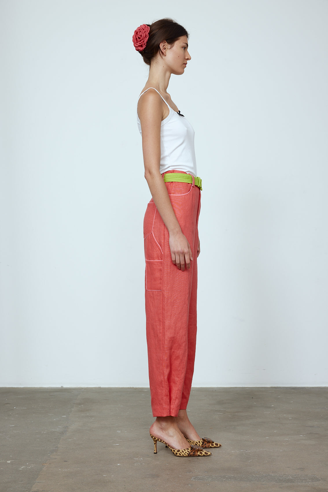 The Emma Pants in Orange Linen. The pants feature cargo details on the side and large pockets with piping details in a contrasting color. Easily modify the shape of the pants with a button adjustment. Style them with a t-shirt, blouse, or a matching Emma Jacket in Orange Linen. Also available in Pink and Navy.