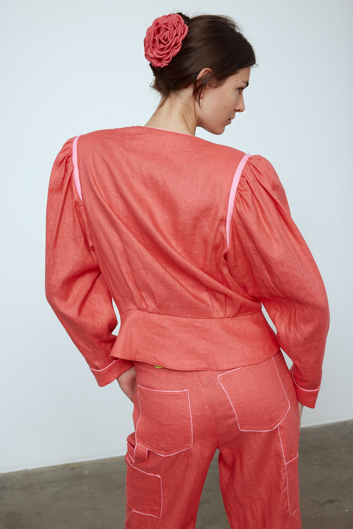 The Emma Jacket in Orange Linen. A new flattering jacket shape inspired by Caroline's favorite vintage 70's finds. The Jacket features a single-button closing, balloon sleeves, and contrasting color piping details around the edges. Also available in Pink/Green and Navy.
