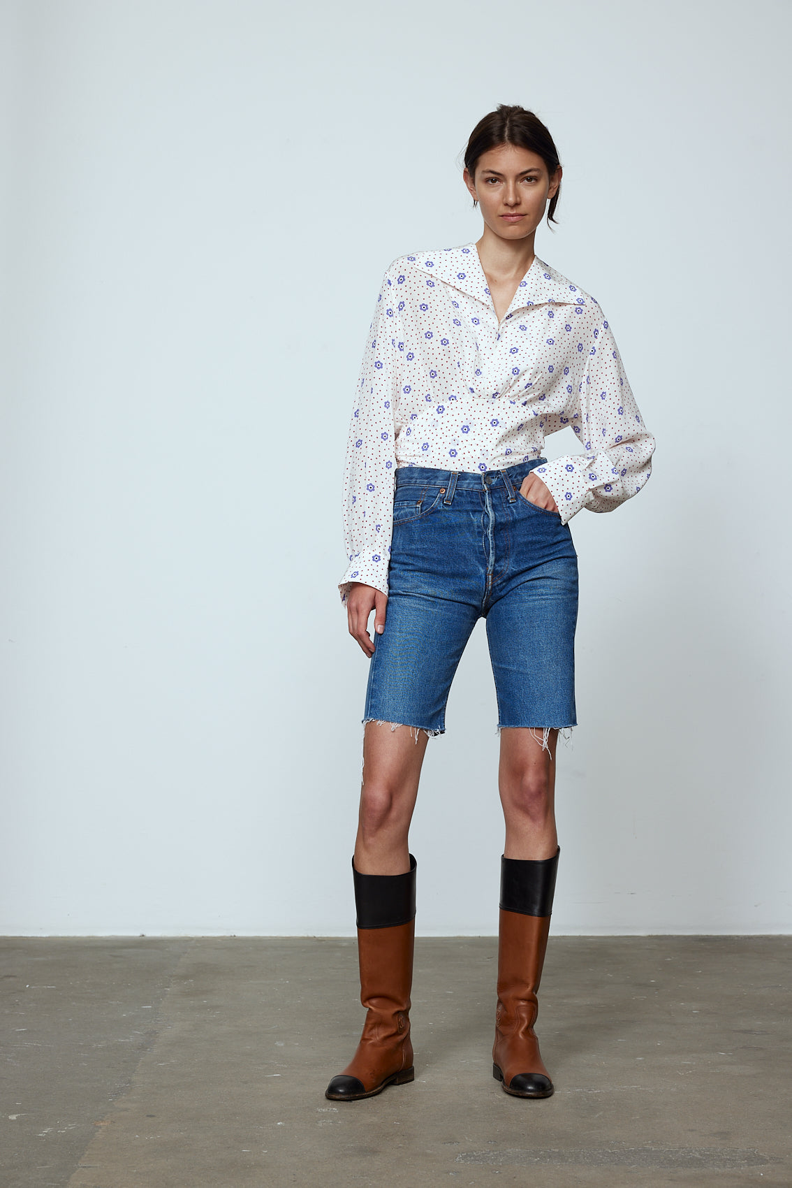 The Nikita Blouse in White Daisy Silk. This shirt features a fitted waist and signature Caro Editions sleeves with cuffs inspired by the party vibe of the 70s. Style it on its own or with a top underneath. Also available in Pale Pink Silk.