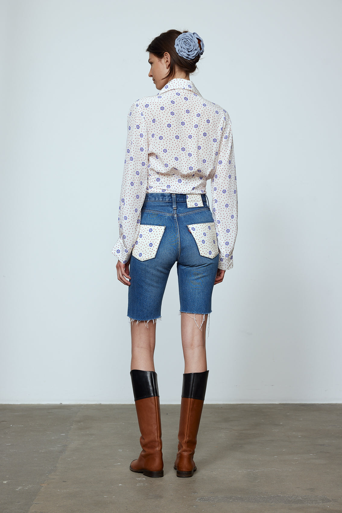 The Nikita Blouse in White Daisy Silk. This shirt features a fitted waist and signature Caro Editions sleeves with cuffs inspired by the party vibe of the 70s. Style it on its own or with a top underneath. Also available in Pale Pink Silk.
