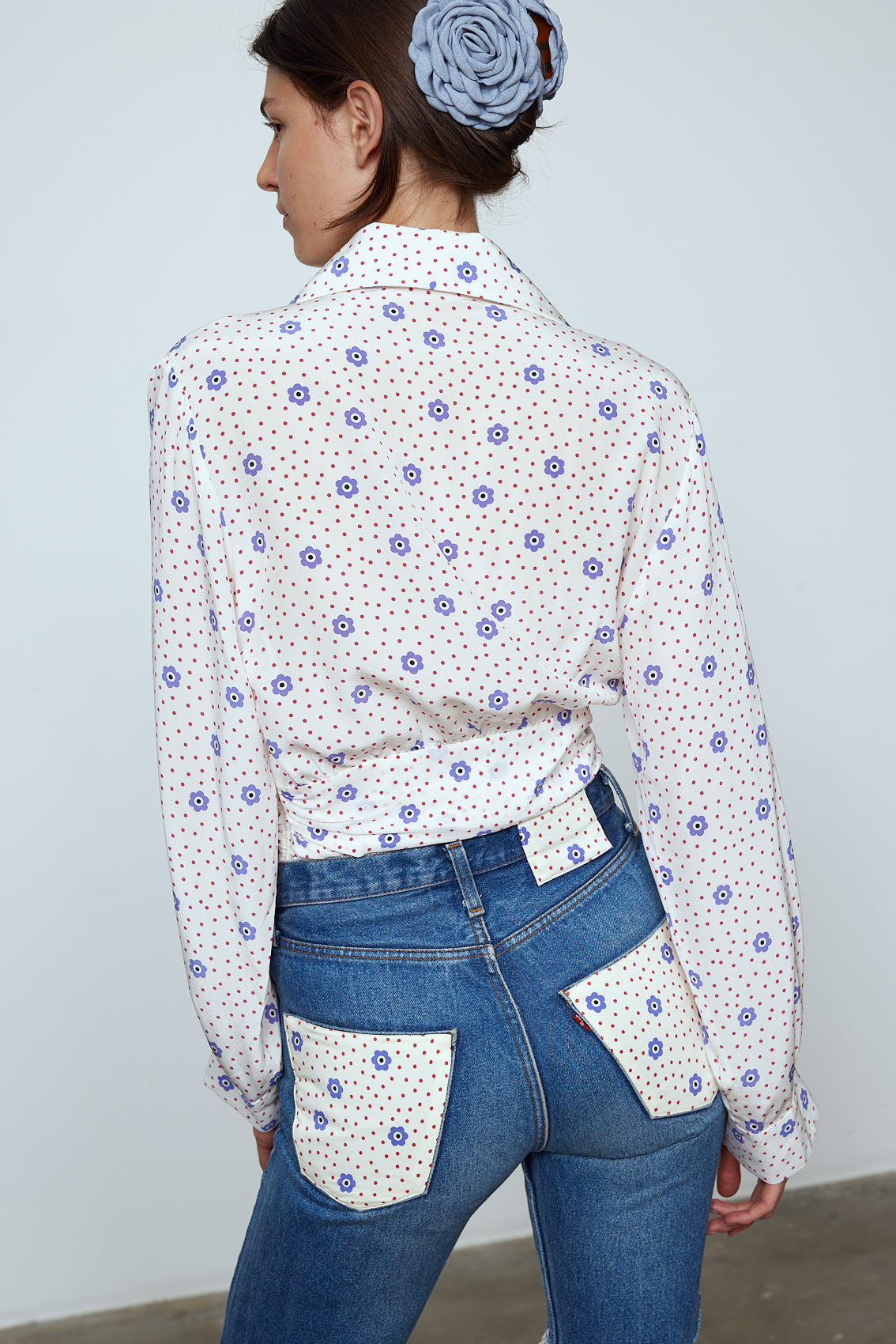 The Nikita Blouse in White Daisy Silk. This shirt features a fitted waist and signature Caro Editions sleeves with cuffs inspired by the party vibe of the 70s. Style it on its own or with a top underneath. Also available in Pale Pink Silk.