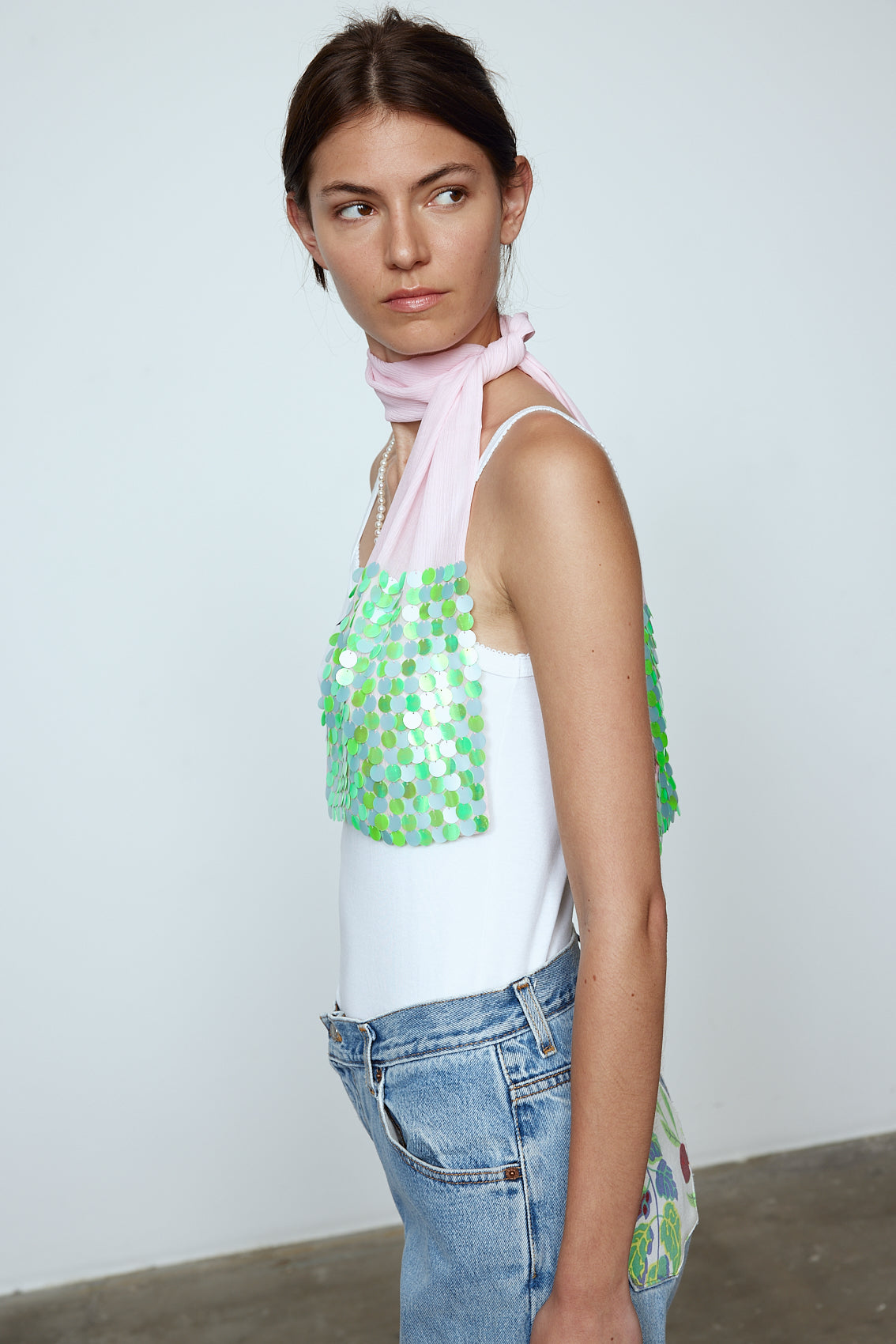 The Ursula Scarf in Pale Pink silk with light green sequins. Use it to dress up any outfit. Material: 100% silk, Beading: 100% polyester.