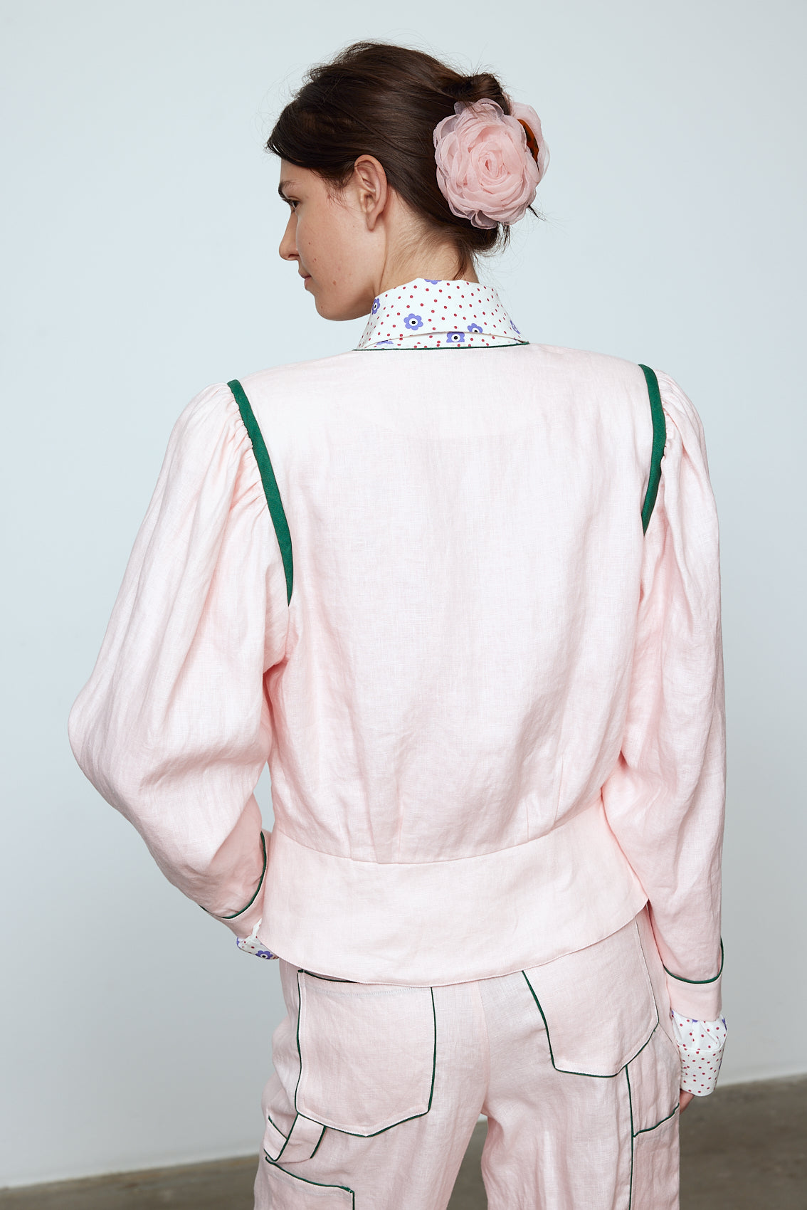 The Emma Jacket in Baby Pink Linen. A new flattering jacket shape inspired by Caroline's favorite vintage 70's finds. The Jacket features a single-button closing, balloon sleeves, and contrasting color piping details around the edges. Also available in Navy and Orange/Pink.