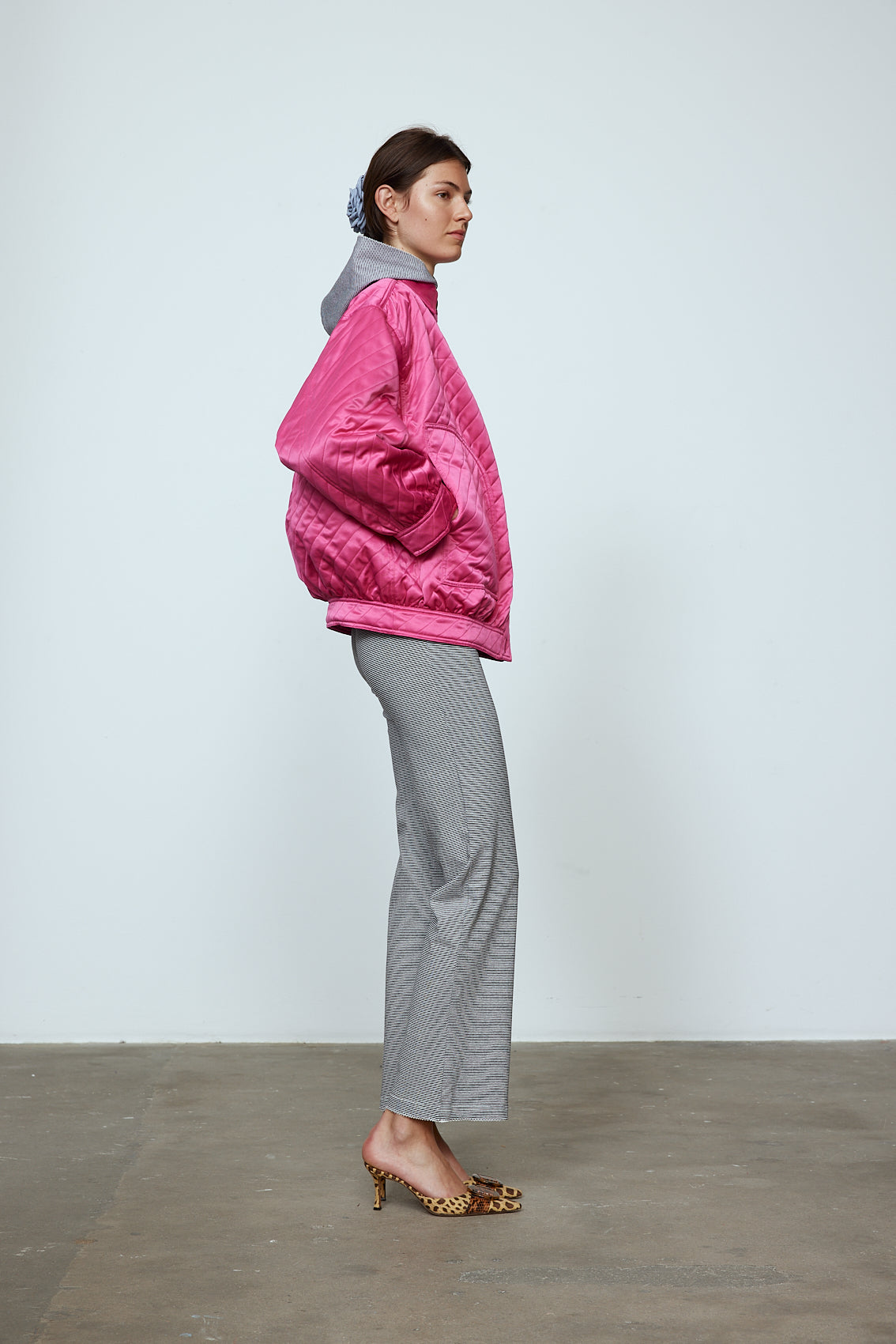 The Mimi Jacket in Hot Pink Duchess. A new rounded shape inspired by the 80s in shiny quilted fabric with orange lining and big round buttons. Style it over dresses, jeans, or leggings. Material: 100% polyester. Lining: 100 % viscose.