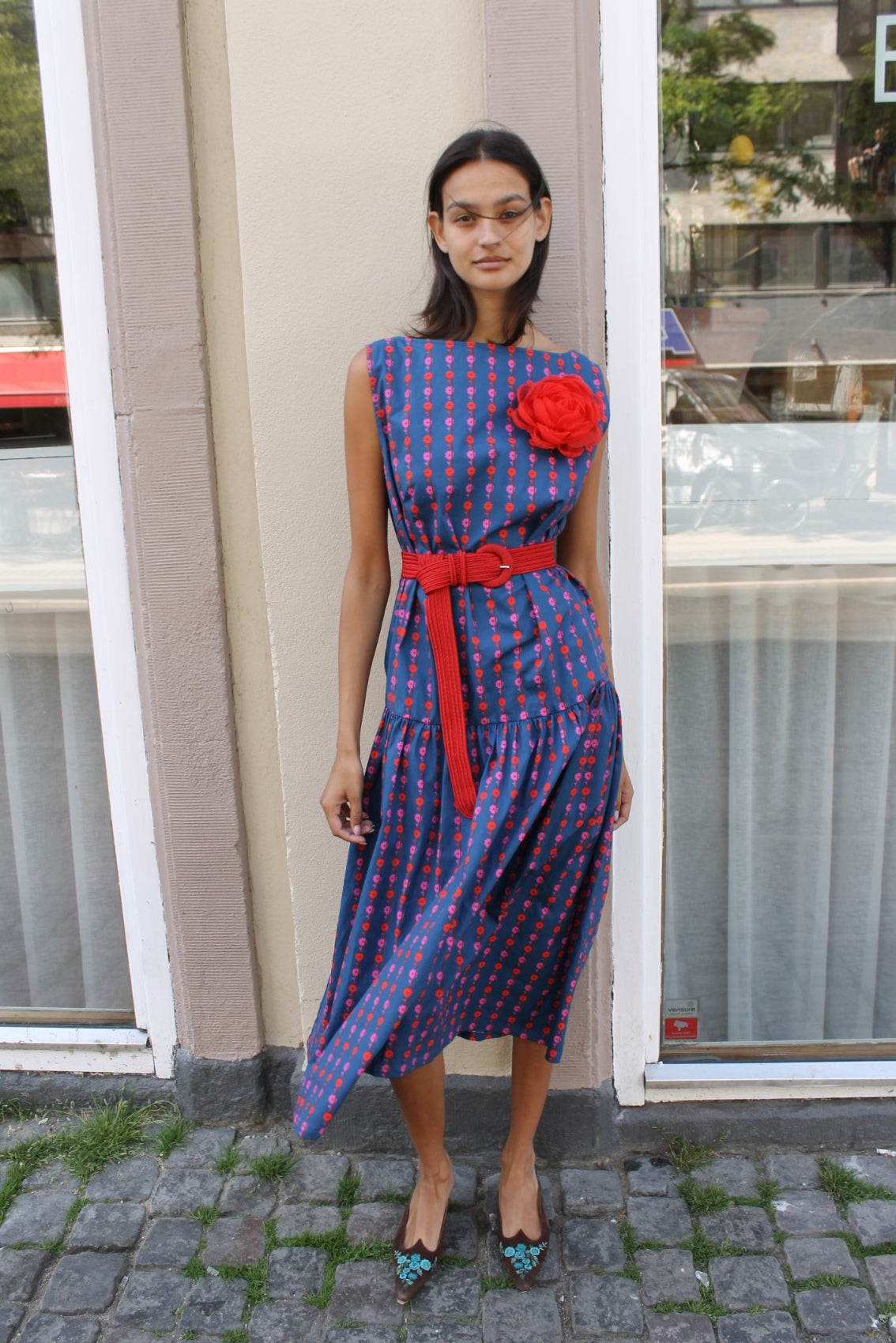 The Fanny Belt in Red with a red buckle. Use it with pants or dresses to alter the fit and add color to your outfit. Material: 100% polyester. One size.