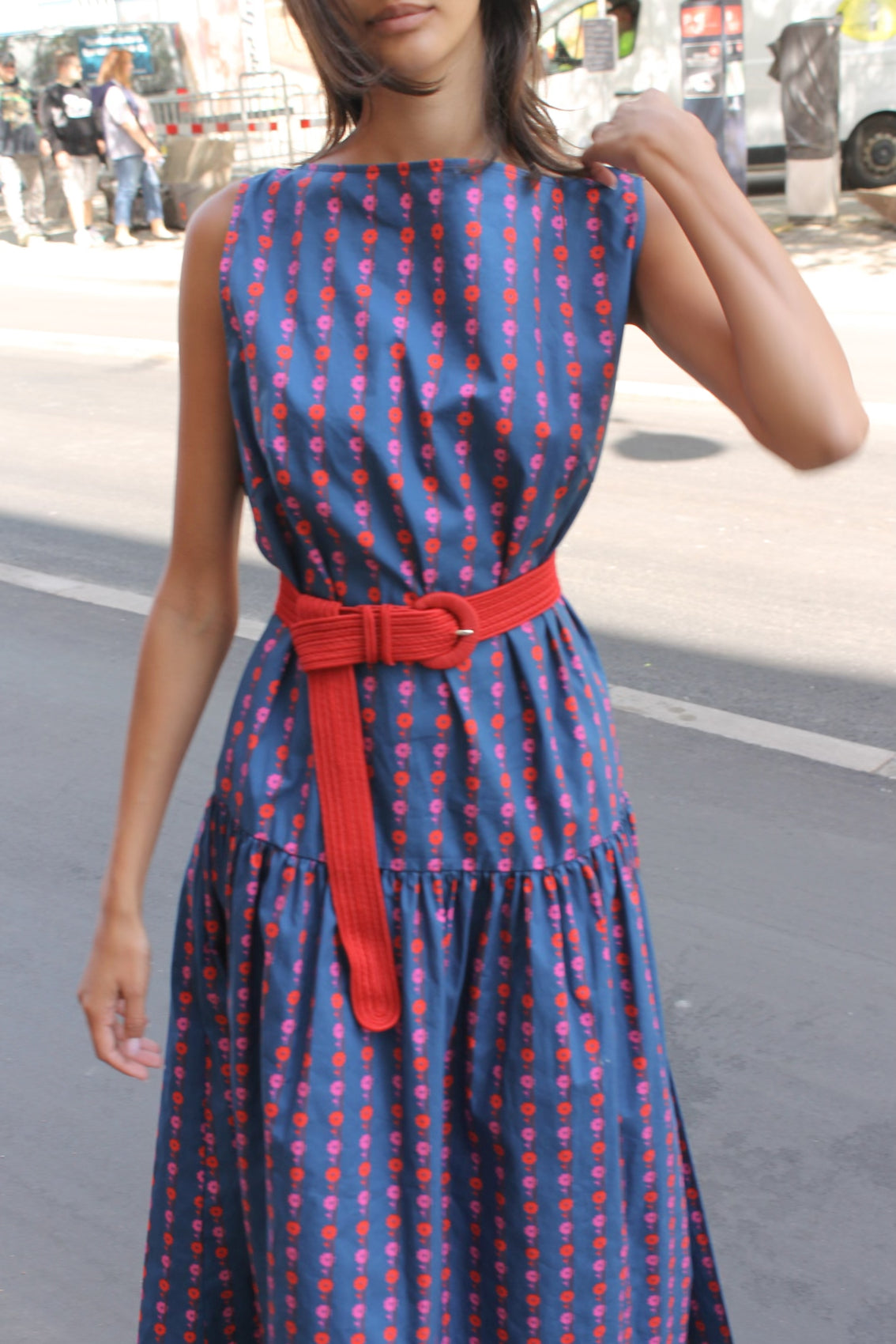 The Fanny Belt in Red with a red buckle. Use it with pants or dresses to alter the fit and add color to your outfit. Material: 100% polyester. One size.