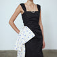 The Sophie Dress is a classic black poplin dress with a big silk bow detail on the side in our blue daisy print. The Dress features wide straps, a slit, and a fitted waist.   Material: 100% cotton. Bow: 100 % silk.  The model is 179cm (5'10") and wears size S.