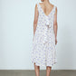 The Sonya Dress is an oversized style with a high neckline and low back featuring a large bow detail. The dress is made from soft mulberry silk featuring a White Daisy print. Style it with an open shirt or denim jacket.  Also available in Beaded Emerald Silk Velvet, Navy Flower Poplin, and Black Silk Velvet.  Material: 100% cotton.
