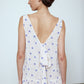 The Sonya Dress is an oversized style with a high neckline and low back featuring a large bow detail. The dress is made from soft mulberry silk featuring a White Daisy print. Style it with an open shirt or denim jacket.  Also available in Beaded Emerald Silk Velvet, Navy Flower Poplin, and Black Silk Velvet.  Material: 100% cotton.