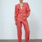 The Emma Pants in Orange Linen. The pants feature cargo details on the side and large pockets with piping details in a contrasting color. Easily modify the shape of the pants with a button adjustment.  Style them with a t-shirt, blouse, or a matching Emma Jacket in Orange Linen.   Also available in Pink and Navy.