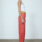 The Emma Pants in Orange Linen. The pants feature cargo details on the side and large pockets with piping details in a contrasting color. Easily modify the shape of the pants with a button adjustment.  Style them with a t-shirt, blouse, or a matching Emma Jacket in Orange Linen.   Also available in Pink and Navy.