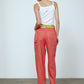The Emma Pants in Orange Linen. The pants feature cargo details on the side and large pockets with piping details in a contrasting color. Easily modify the shape of the pants with a button adjustment.  Style them with a t-shirt, blouse, or a matching Emma Jacket in Orange Linen.   Also available in Pink and Navy.
