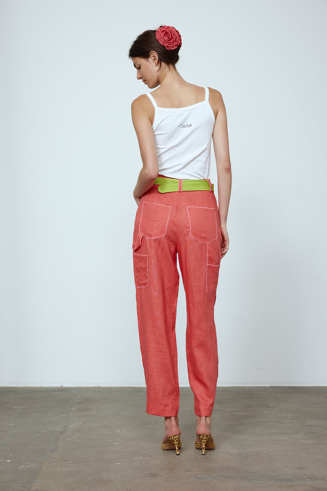 The Emma Pants in Orange Linen. The pants feature cargo details on the side and large pockets with piping details in a contrasting color. Easily modify the shape of the pants with a button adjustment.  Style them with a t-shirt, blouse, or a matching Emma Jacket in Orange Linen.   Also available in Pink and Navy.