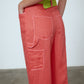 The Emma Pants in Orange Linen. The pants feature cargo details on the side and large pockets with piping details in a contrasting color. Easily modify the shape of the pants with a button adjustment.  Style them with a t-shirt, blouse, or a matching Emma Jacket in Orange Linen.   Also available in Pink and Navy.