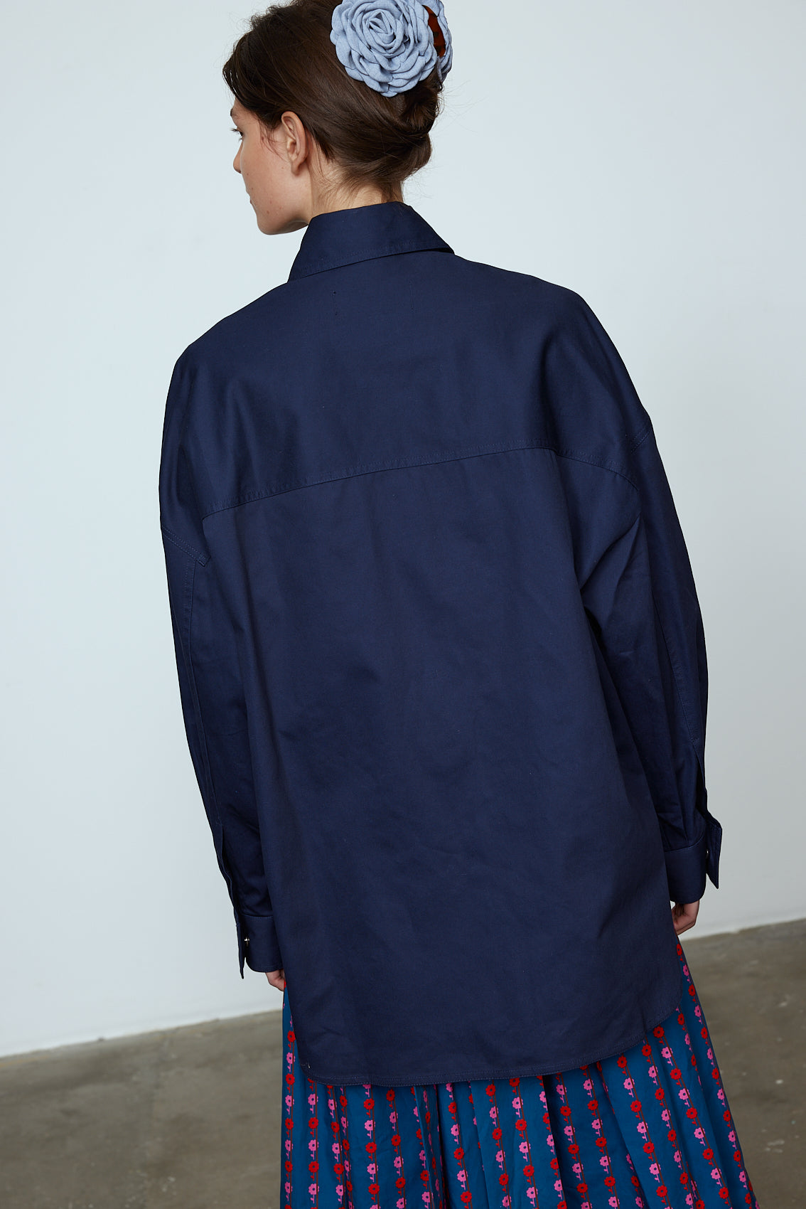 The Frederik Shirt is an oversized cotton style with big sleeves, green pockets, and an embroidered Caro logo on the front.  Style it open over a dress, tank top, or t-shirt or buttoned up on its own.  Material: 100% cotton.  The model is 179cm (5'10") and wears size S.