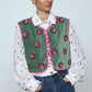The Ravnbak Vest in Olive Green velvet with a pink lining. The vest is exquisitely hand-embroidered by skilled artisans in our flower daisy pattern using beadings and sequins. Style it over a shirt, dress, or top.  Also available in Baby Pink.