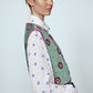 The Ravnbak Vest in Olive Green velvet with a pink lining. The vest is exquisitely hand-embroidered by skilled artisans in our flower daisy pattern using beadings and sequins. Style it over a shirt, dress, or top.  Also available in Baby Pink.