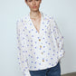The Bonsai Shirt is made in soft silk fabric featuring our White Daisy print. The Shirt has long draped sleeves, a deep-cut oversized shirt collar, and buttons on the front.   Style it with jeans and a colorful belt, together with a vest or denim jacket.   Material: 100% mulberry silk.  The model is 179cm (5'10") and wears size S.