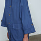 The Anna Coat in French Blue Canvas. The jacket is inspired by vintage work-wear with wide sleeves, cuffs, and button closing on the front.  Material: 100% cotton.