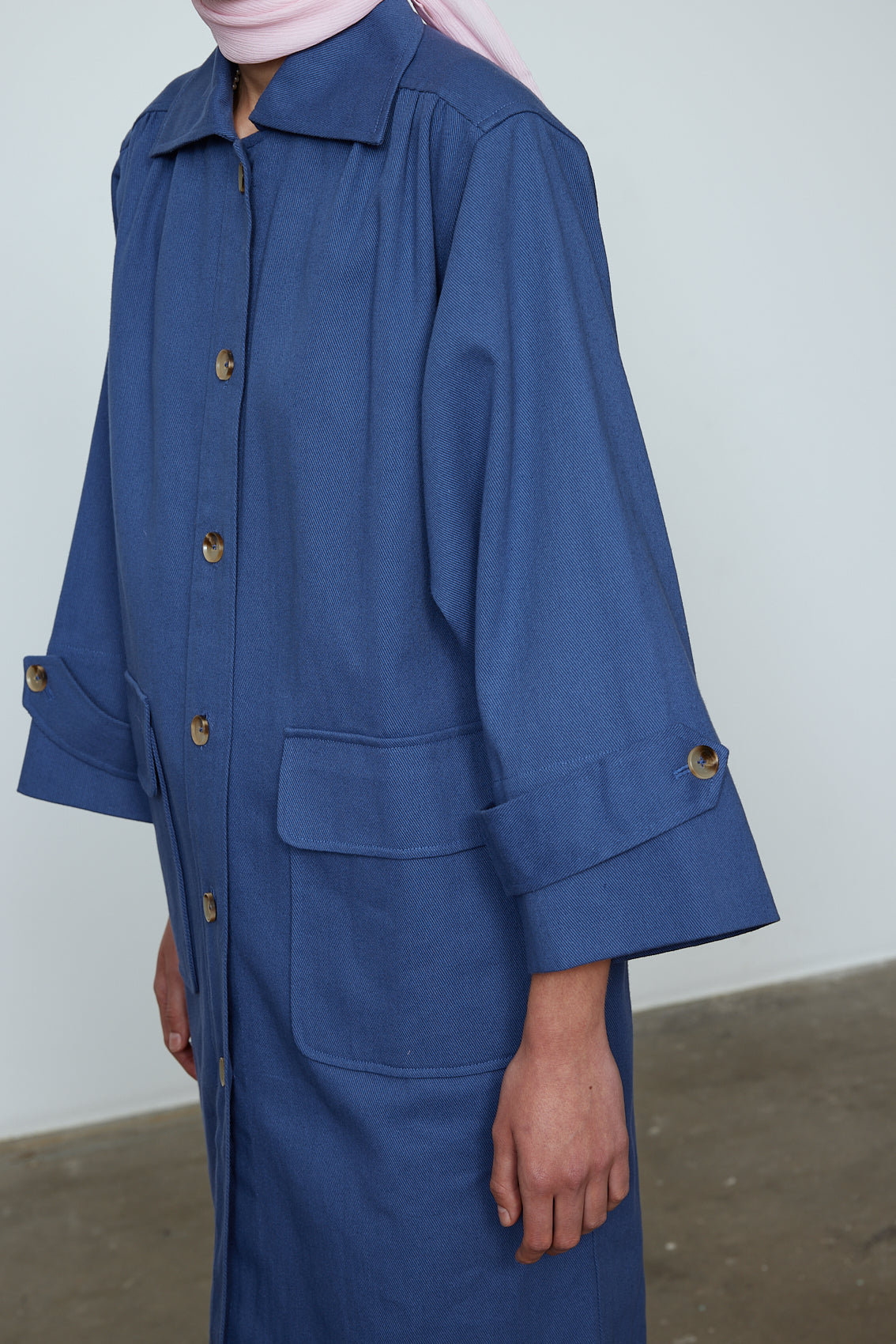 The Anna Coat in French Blue Canvas. The jacket is inspired by vintage work-wear with wide sleeves, cuffs, and button closing on the front.  Material: 100% cotton.