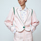 The Emma Jacket in Baby Pink Linen. A new flattering jacket shape inspired by Caroline's favorite vintage 70's finds. The Jacket features a single-button closing, balloon sleeves, and contrasting color piping details around the edges.   Also available in Navy and Orange/Pink.