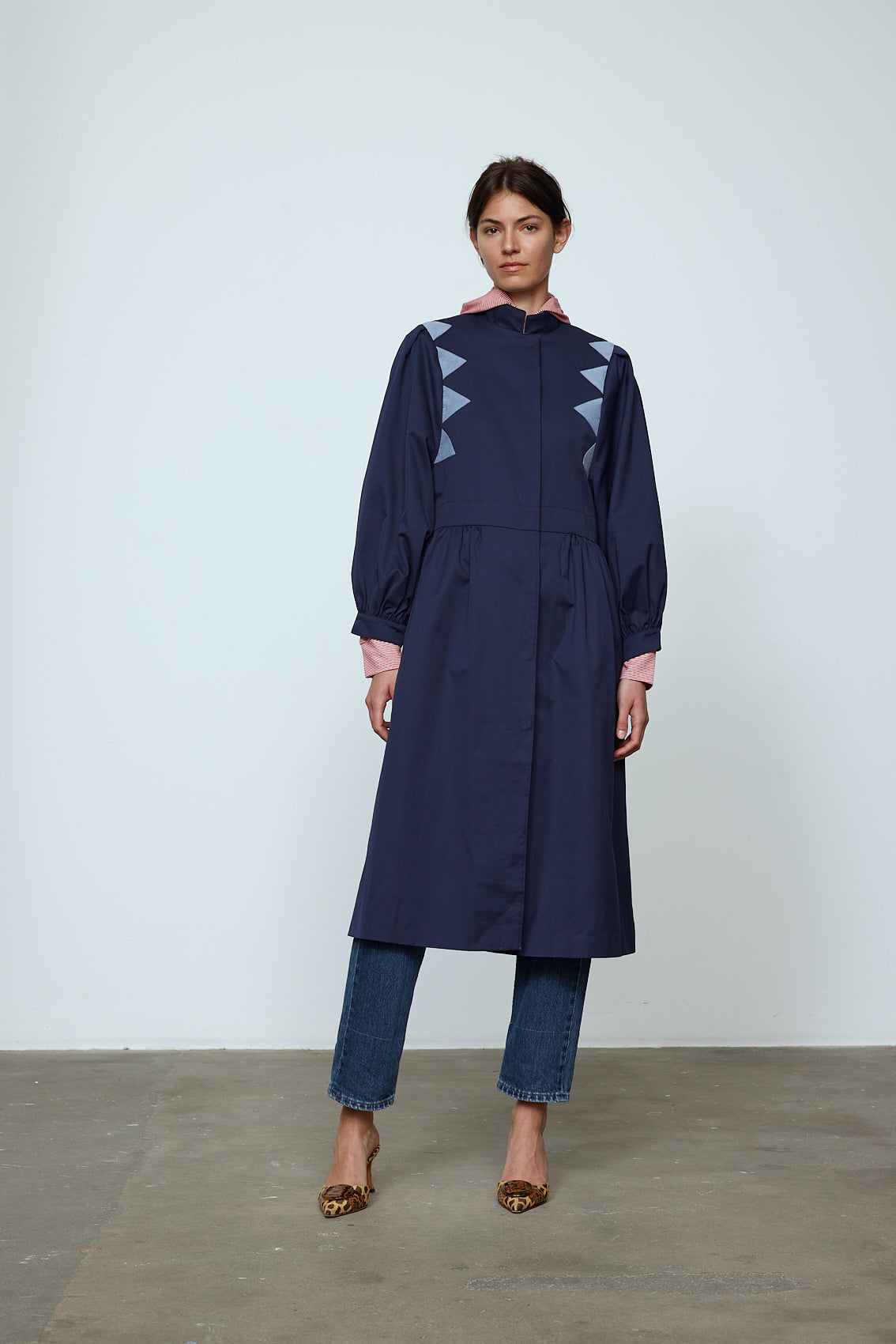 Agnes Coat in Navy Canvas with Dove Blue corduroy triangular details. The Jacket features a hidden push-button closing and balloon sleeves.  Material: Shell: 100% cotton. Lining: 100% viscose.