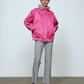 The Mimi Jacket in Hot Pink Duchess. A new rounded shape inspired by the 80s in shiny quilted fabric with orange lining and big round buttons.  Style it over dresses, jeans, or leggings.   Material: 100% polyester. Lining: 100 % viscose.