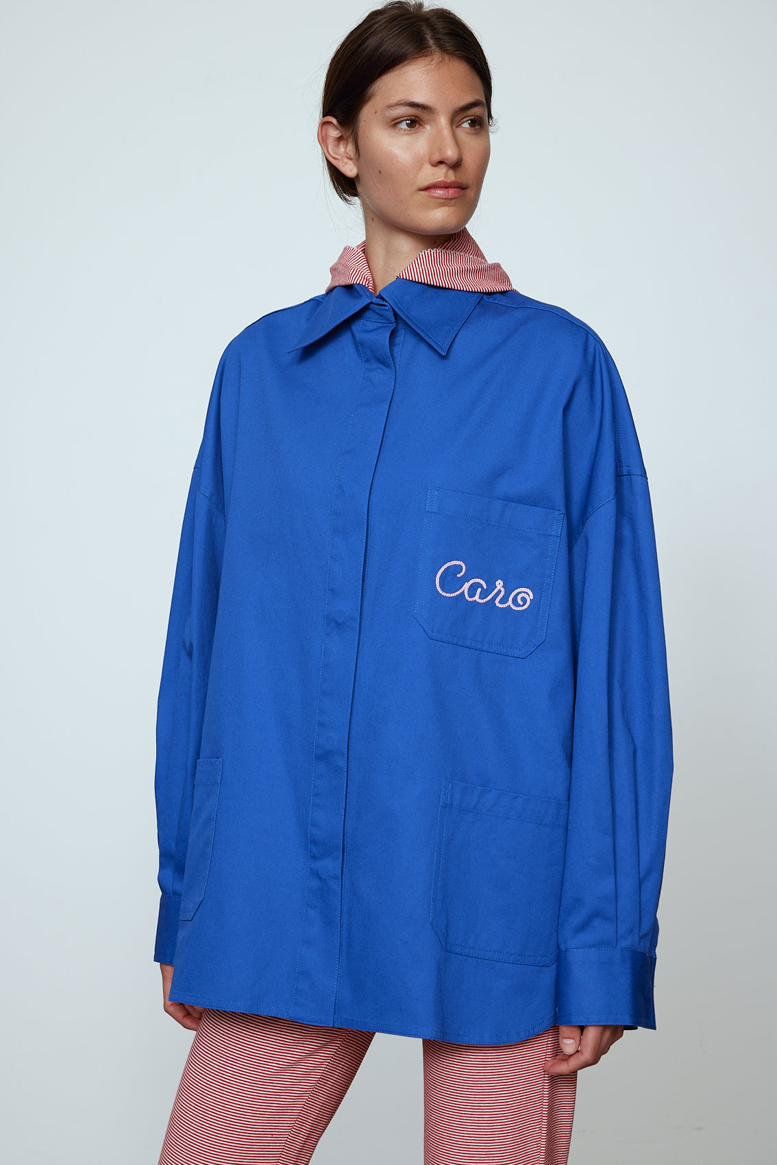 The Frederik Shirt is an oversized cotton style with big sleeves and an embroidered Caro logo on the front.  Style it open over a dress, tank top, or t-shirt or buttoned up on its own.  Material: 100% cotton.  The model is 179cm (5'10") and wears size S. Inspired by Frederik Bille Brahe. 