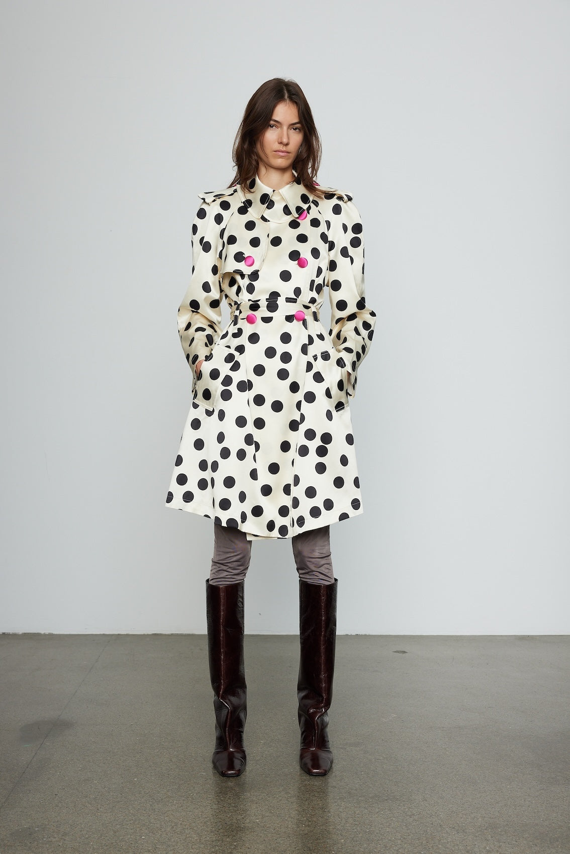 Caro Editions Roberta Coat features a black and white polka dot print on heavy cream-colored silk, with a matching belt and pink silk-covered buttons.  Material: 100% Silk.
