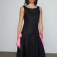 Caro Editions Margrethe Dress is a fitted style made from black linen with a round neckline, low back, drop waist and a draped skirt for extra volume. The half belt on this dress features side bows in pink linen. Material: 100% Silk.