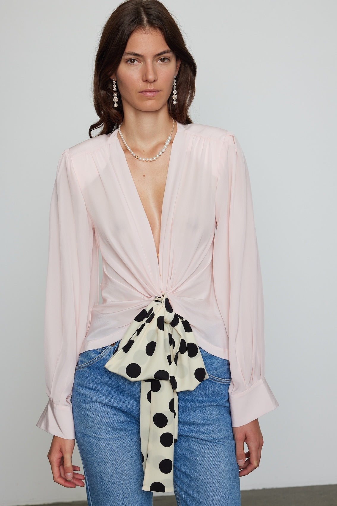 Caro Editions Our Agnete Blouse is the perfect party top, made in soft and light Silk Crepe de Chine fabric. It features a deep v-neck blouse and Caro's signature long draped sleeves. The fit is waist-accentuating while comfortable to wear.   Material: 100% Silk.