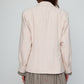 Caro Editions The Annika Jacket in a classic houndstooth tweed The jacket features a single-button closing at the front, wide padded shoulders, and large front pockets. The jacket is slightly fitted around the waist.  Material: 100% wool. Lining: 100% viscose.