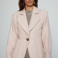 Caro Editions The Annika Jacket in a classic houndstooth tweed The jacket features a single-button closing at the front, wide padded shoulders, and large front pockets. The jacket is slightly fitted around the waist.  Material: 100% wool. Lining: 100% viscose.