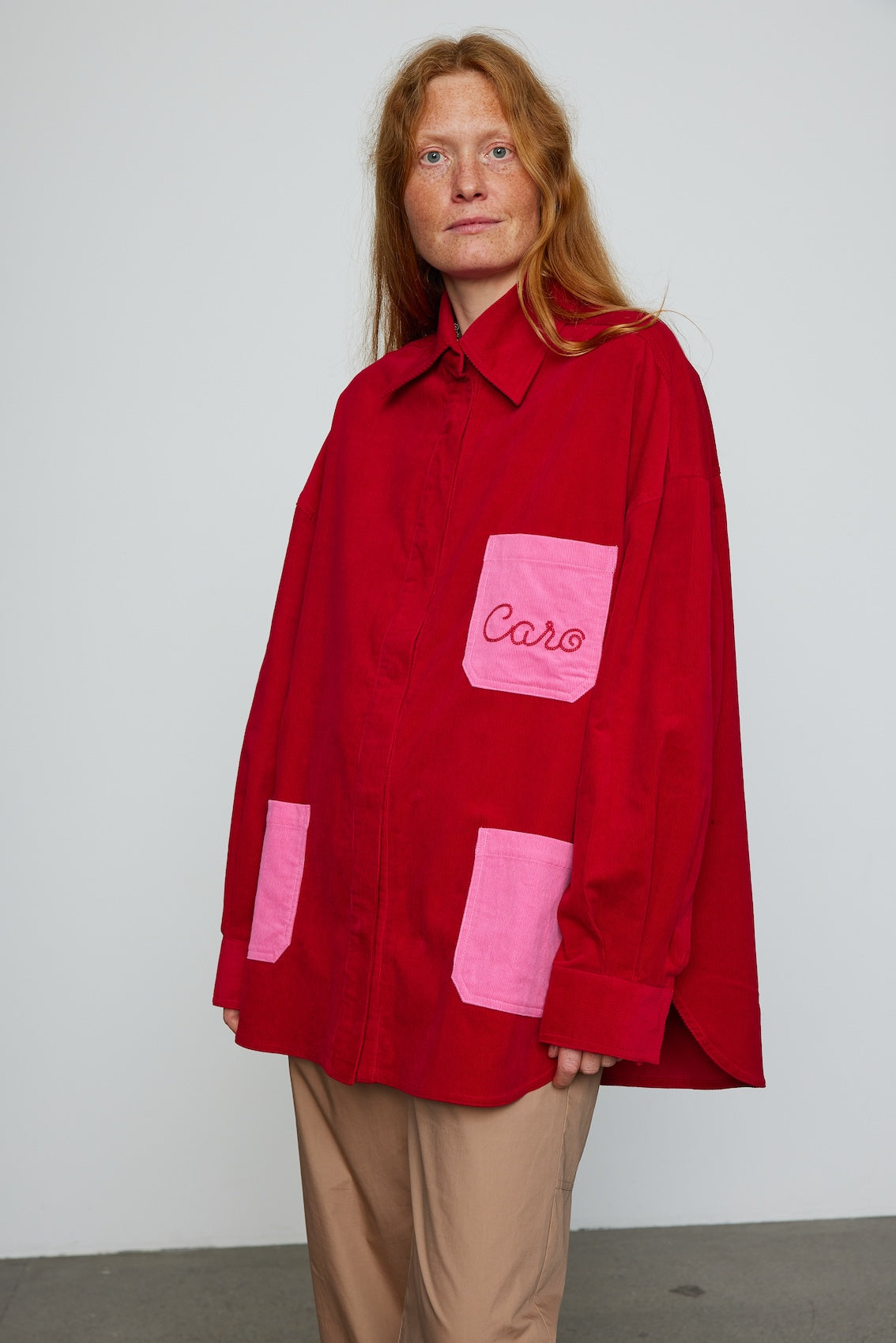 Caro Editions Frederik Shirt is an oversized cotton corduroy style with big sleeves, pink pockets, and an embroidered Caro logo.  Style it open over a dress, tank top, or t-shirt, or wear it buttoned-up.
