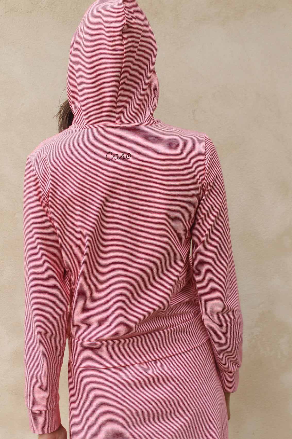 Caro Editions' new signature line in jersey cotton.  The Caro PJ Hoodie is a slightly fitted style with long sleeves, a zipper opening on the front, and embroidered Caro Editions logo on the back.   Also available in Black White stripe.  Style the Caro PJ Hoodie under a jacket or shirt, with matching Caro PJ Leggings, jeans, or a skirt.  Material: 95% cotton, 5% elastane. Bow: 100% Polyester.  The model is 179cm (5'10") and is wearing a size S.