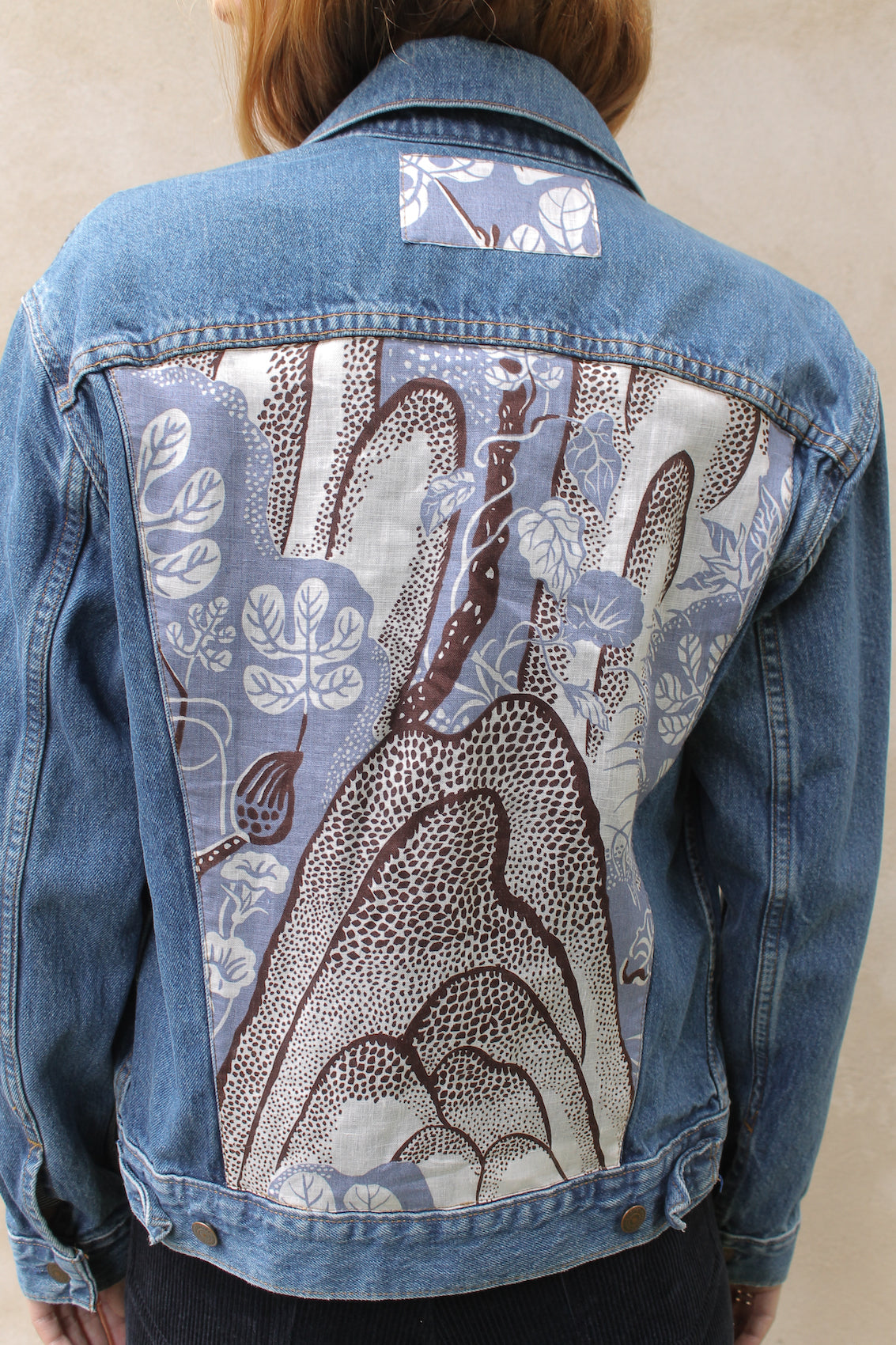 Upcycled vintage denim jacket redesigned with patchwork in exclusive Josef Frank vintage fabric with a green floral print. One-of-a-kind.  Size: S/M