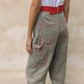 The Emma Pants in Khaki Linen. The pants feature cargo details on the side and large pockets with piping details in a contrasting color. Easily modify the shape of the pants with a button adjustment.  Style them with a t-shirt, blouse, or a matching Emma Jacket in Khaki.  Also available in Orange, Pink and Navy.  Material: 100% linen. Lining: 100% viscose.  The model is 175cm (5'9") and is wearing a size S.
