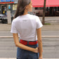 Caro Editions' new signature line in jersey cotton.  The Caro T-shirt is a fitted style with short sleeves, a ribbon bow detail at the front, and embroidered Caro Editions logo on the back.   Also available in Red White stripe, and Black White stripe.  Style the Caro T-shirt under shirts or dresses, or wear them on their own.  Material: 95% cotton, 5% elastane. Bow: 100% Polyester.  The model is 175cm (5'9") and is wearing a size S.