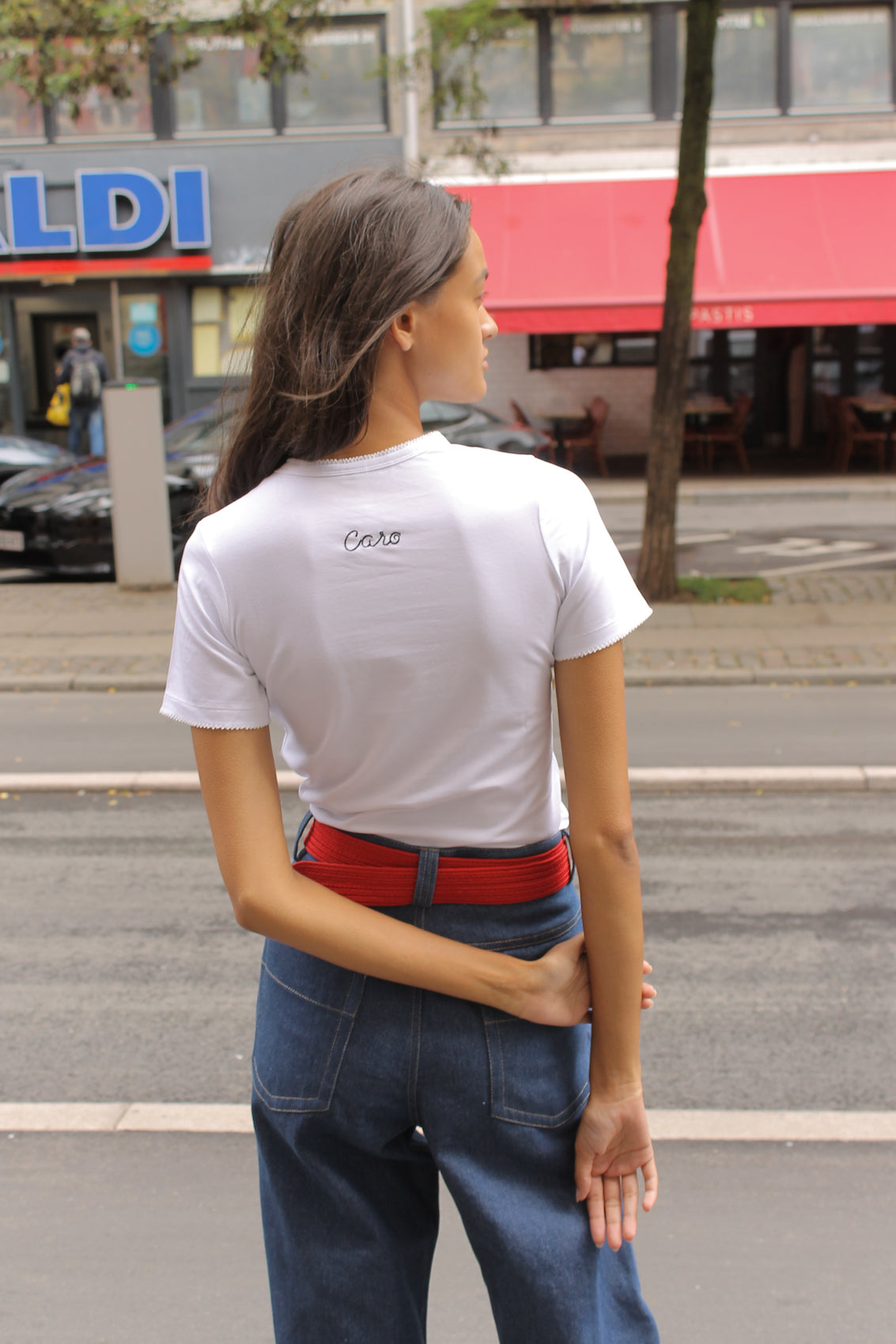 Caro Editions' new signature line in jersey cotton.  The Caro T-shirt is a fitted style with short sleeves, a ribbon bow detail at the front, and embroidered Caro Editions logo on the back.   Also available in Red White stripe, and Black White stripe.  Style the Caro T-shirt under shirts or dresses, or wear them on their own.  Material: 95% cotton, 5% elastane. Bow: 100% Polyester.  The model is 175cm (5'9") and is wearing a size S.