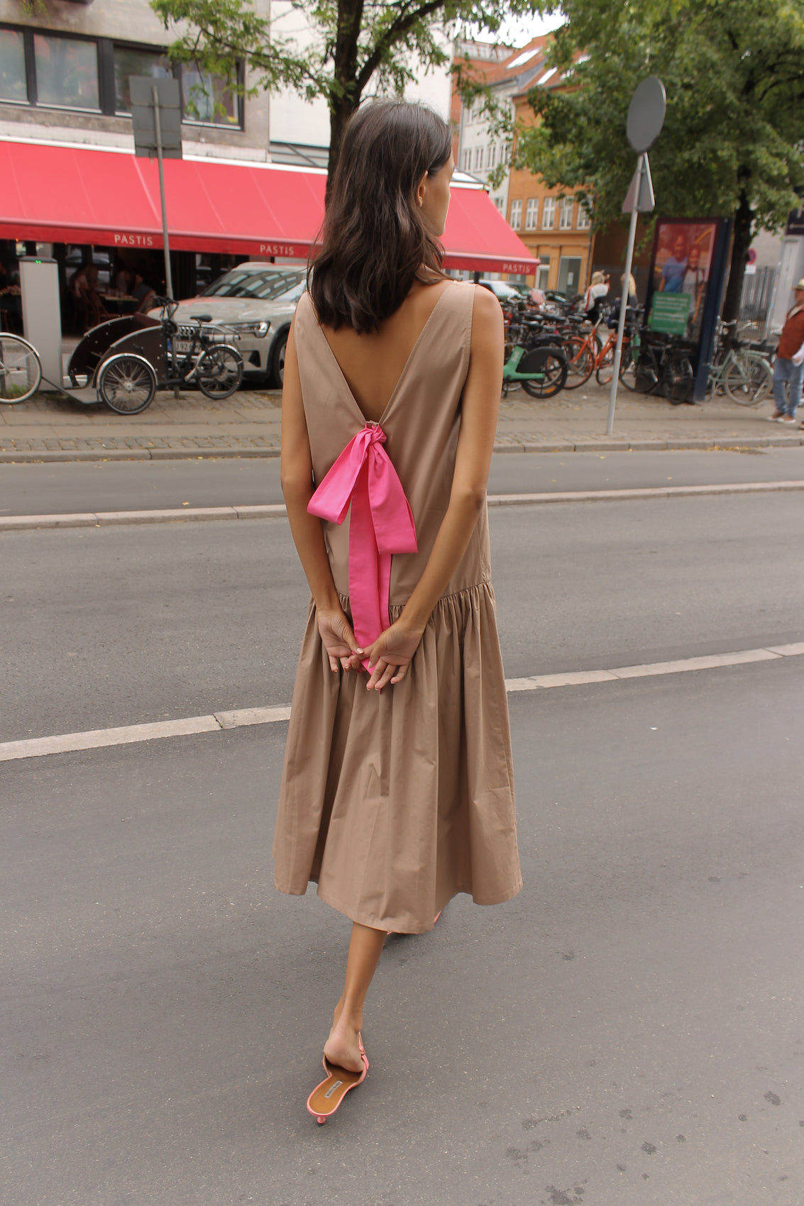The Sonya Dress is an oversized style with a high neckline and low back featuring a large bow detail. The dress is made in crispy cotton poplin. Style it with an open shirt or denim jacket.  Also available in Navy Flower Poplin, White Flower Poplin, Beaded Emerald Silk Velvet, White Daisy Silk, and Black Silk Velvet.  Material: 100% cotton.  The model is 175cm (5'9") and is wearing a size S.