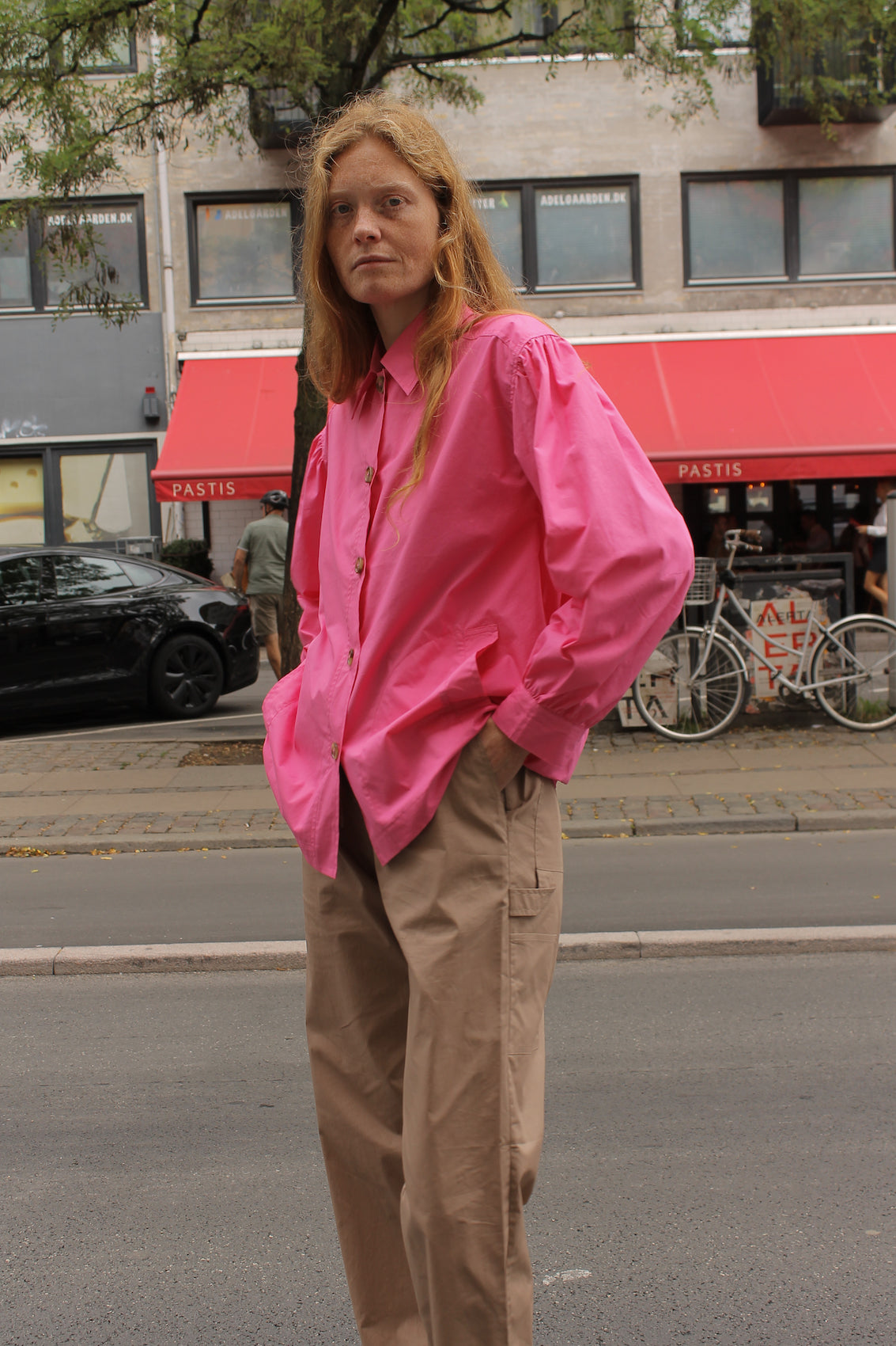 The Hannah shirt in Pink cotton poplin. The shirt features an oversized fit, big sleeves, and buttons at the front.  Style it with matching Hannah Pants or jeans, or wear it open over a t-shirt or tank top.  Also available in Bottle Green, Navy, Khaki, Navy Flower and White Flower Poplin.   Material: 100% cotton.  The model is 175cm (5'9") and is wearing a size S.