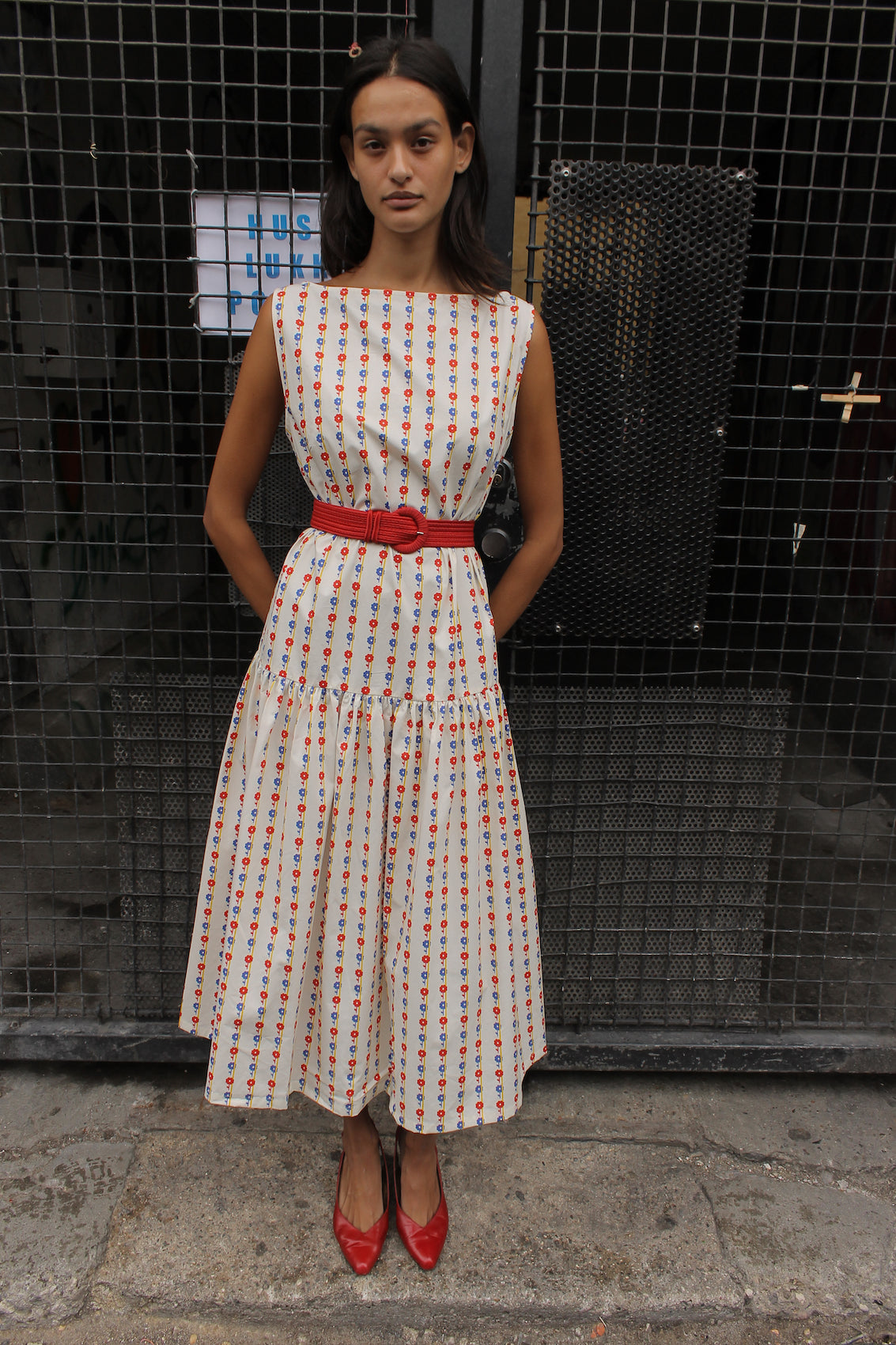 The Sonya Dress is an oversized style with a high neckline and low back featuring a large bow detail. The dress is made in crispy cotton poplin. Style it with an open shirt or denim jacket.  Also available in Navy Flower Poplin, Khaki Poplin, Beaded Emerald Silk Velvet, White Daisy Silk, and Black Silk Velvet.  Material: 100% cotton.  The model is 175cm (5'9") and is wearing a size S.