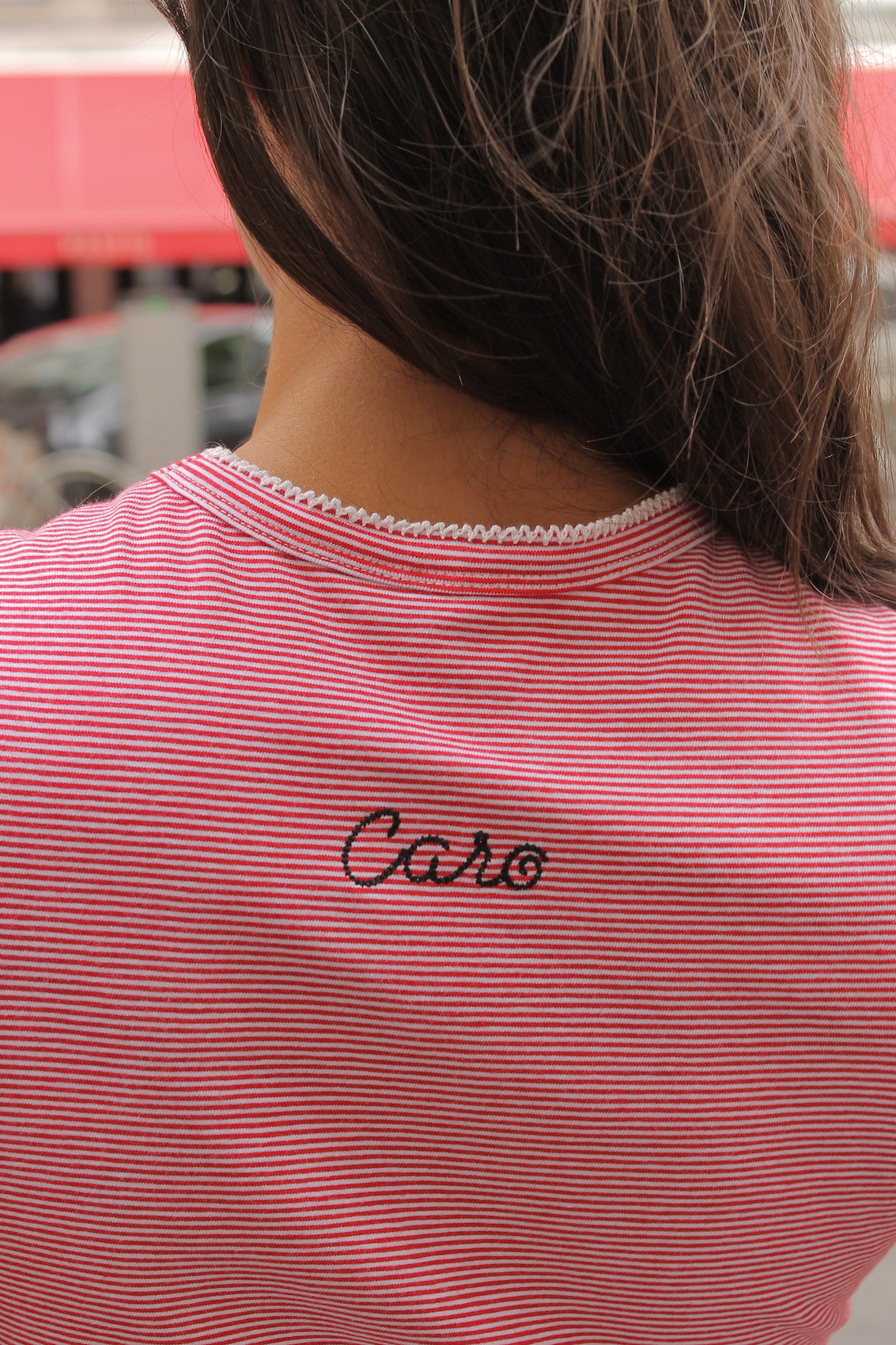 Caro Editions' new signature line in jersey cotton.  The Caro T-shirt is a fitted style with short sleeves, a ribbon bow detail at the front, and embroidered Caro Editions logo on the back.   Also available in White and Black White stripe.  Style the Caro T-shirt under shirts or dresses, or wear them on their own.  Material: 95% cotton, 5% elastane. Bow: 100% Polyester.  The model is 175cm (5'9") and is wearing a size S.